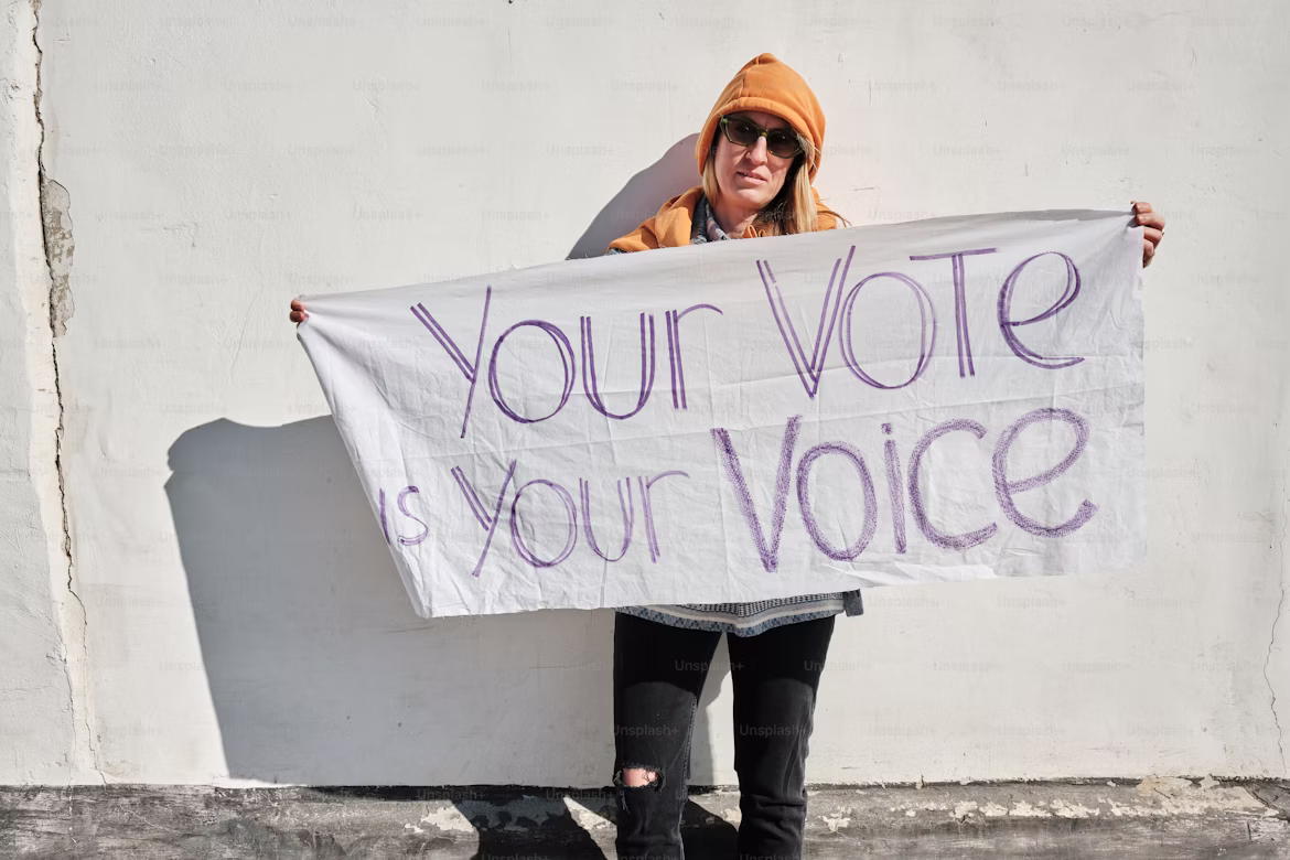 Woman holding a 'vote' flag